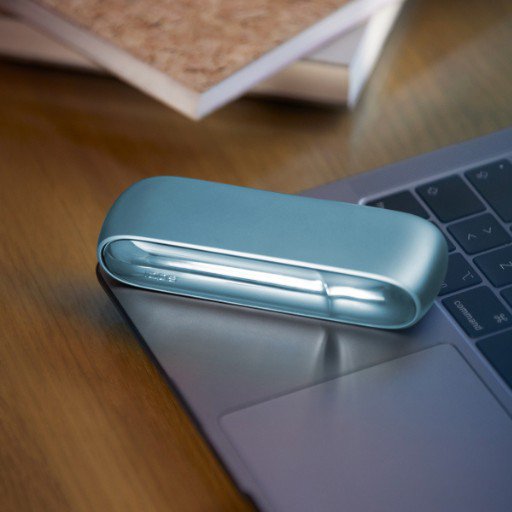 Turquoise IQOS Originals Duo device on a laptop. 