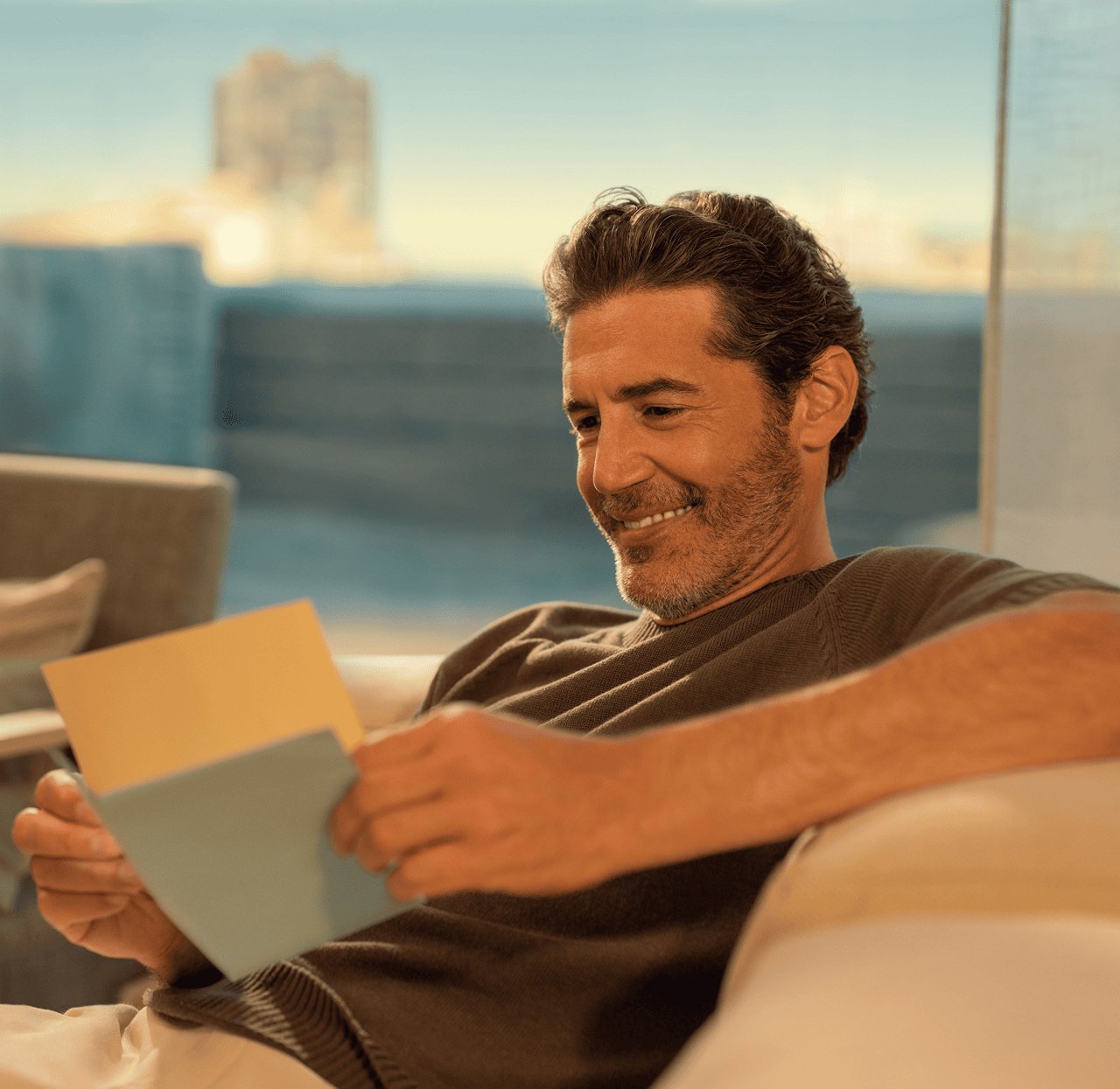 A man holding a letter with his hands