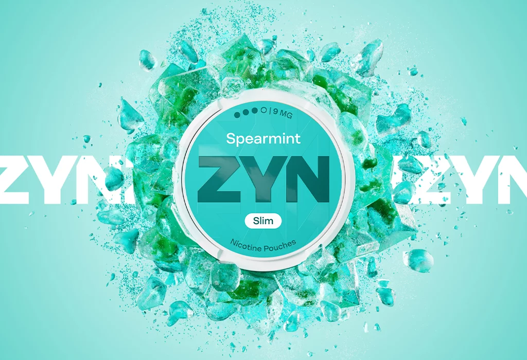 ZYN Spearmint Slim kutijica nikotinskih vrećica 9 mg okružena vizualom mente na svijetlozelenoj pozadini