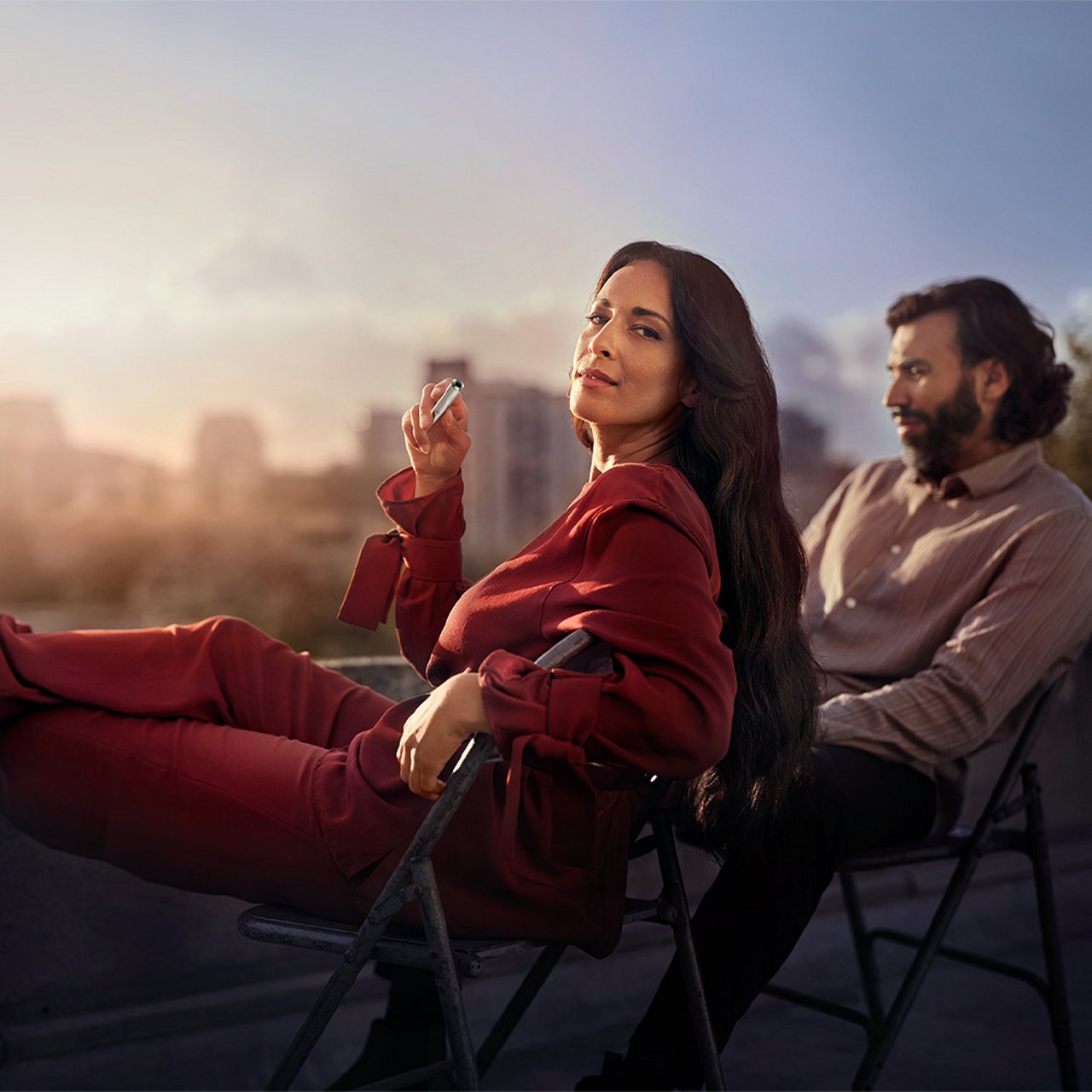 Two friends holding IQOS devices