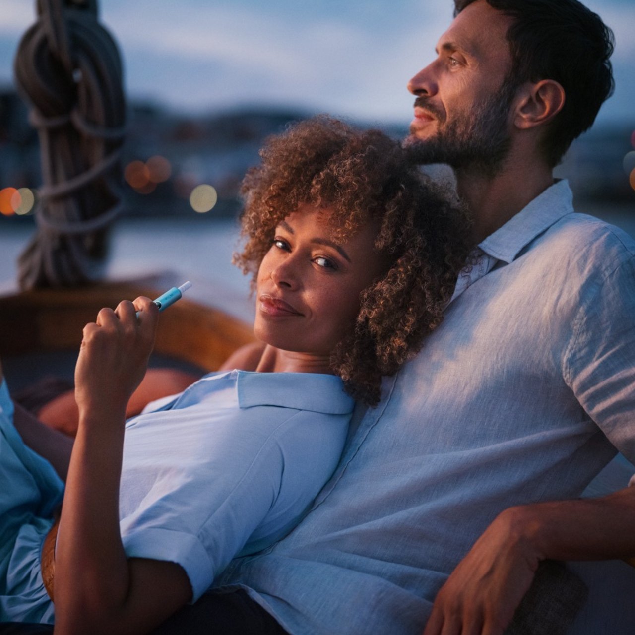 A woman and a man using IQOS