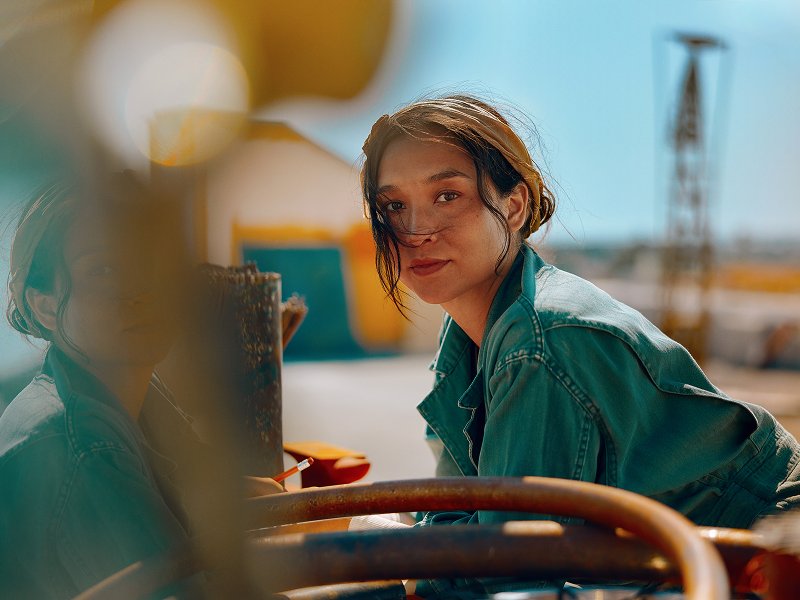 Mujer apoyada mirando a la camara