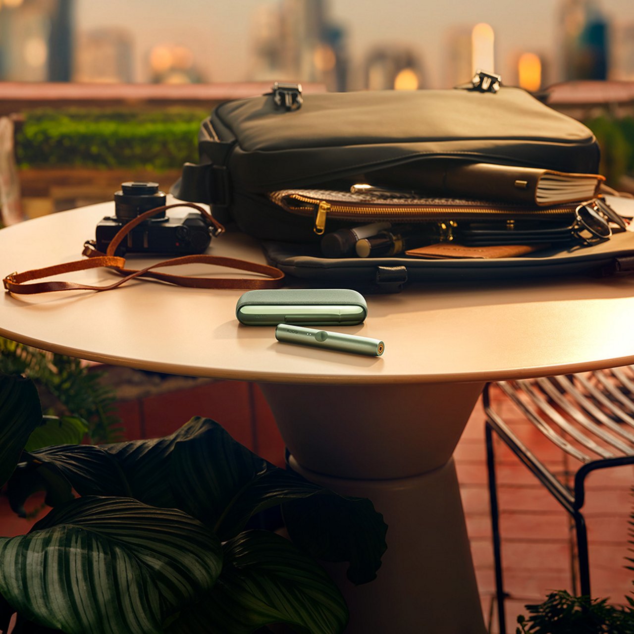 Two friends holding IQOS devices