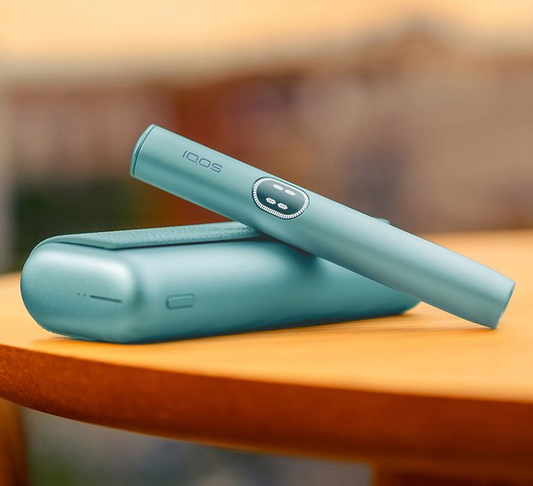  IQOS ILUMA PRIME Breeze Blue on a table