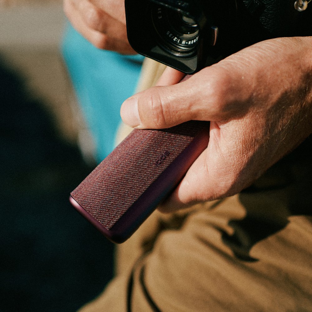Brilliant gold IQOS 3 DUO holder and charger in hand