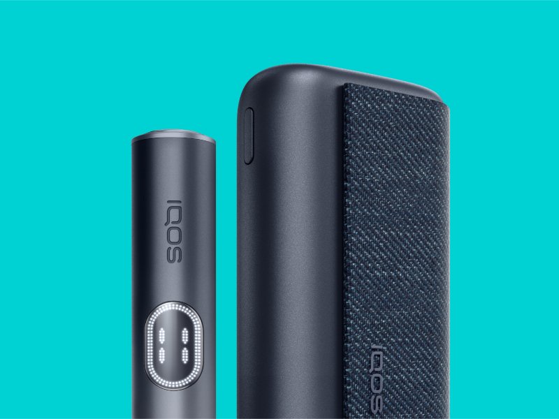 Midnight Black IQOS ILUMA i Prime holder and charger with turquoise background