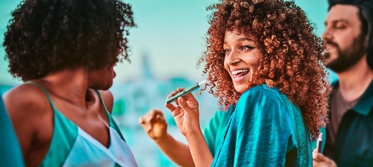 Two women with IQOS Originals device
