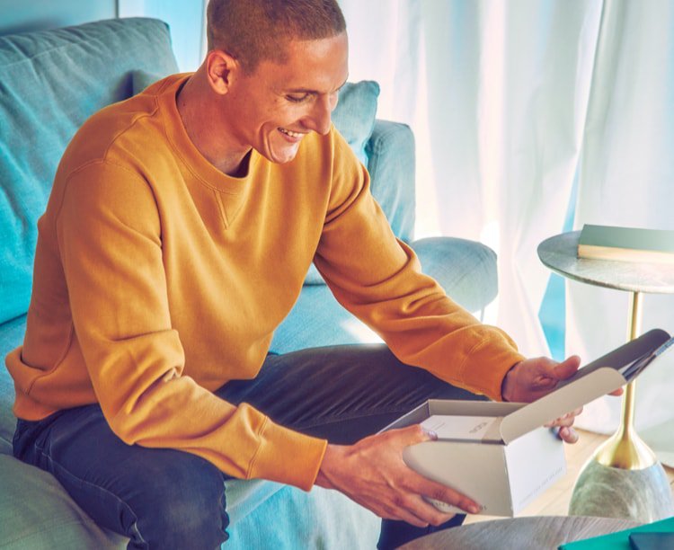 Young man opens his IQOS gift box