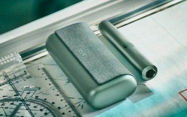 A Jade Green IQOS ILUMA PRIME Pocket Charger and Holder.