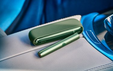 A Moss Green IQOS ILUMA Pocket Charger and Holder.