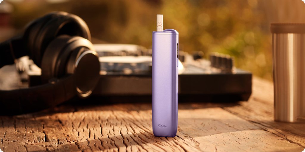 Blue IQOS ILUMA i ONE device on wooden table