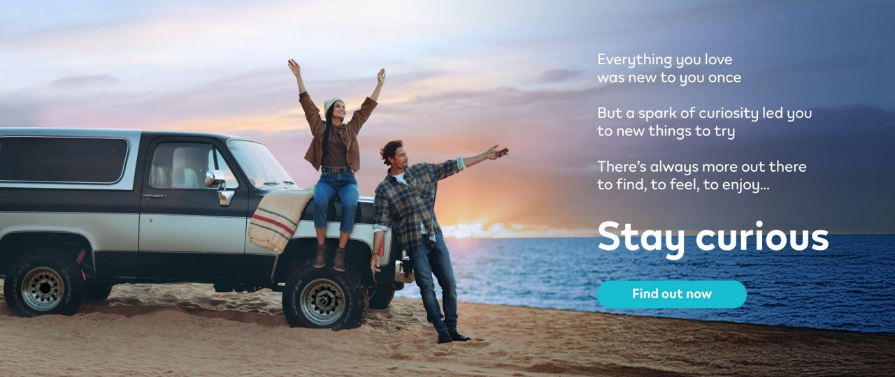 Stay Curious IQOS Banner –  A Woman and A Man are standing on a beach with a car