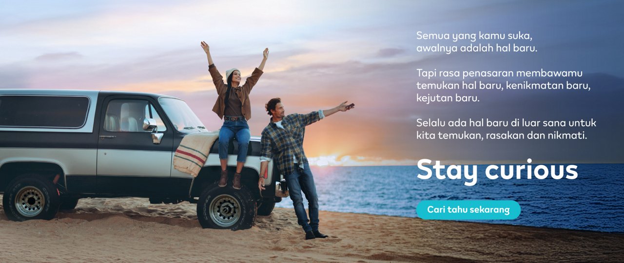 Banner Stay Curious IQOS – Seorang pria dan seorang Wanita berdiri di pnatai dengan sebuah mobil