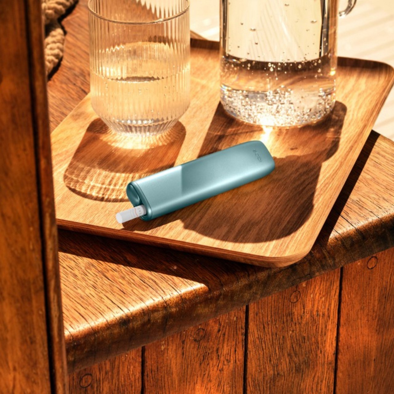 Woman holding IQOS device