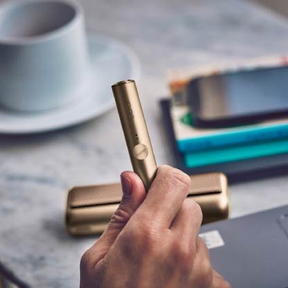 Stellar blue IQOS 3 DUO holder and charger on a music production panel