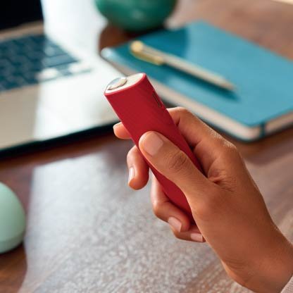 Brilliant gold IQOS 3 DUO holder and charger in hand