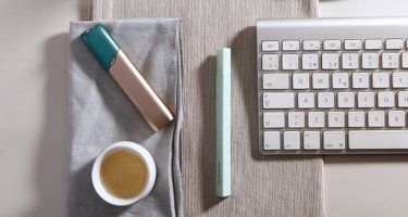 Green and coppery IQOS 3 Multi kit on a working desk