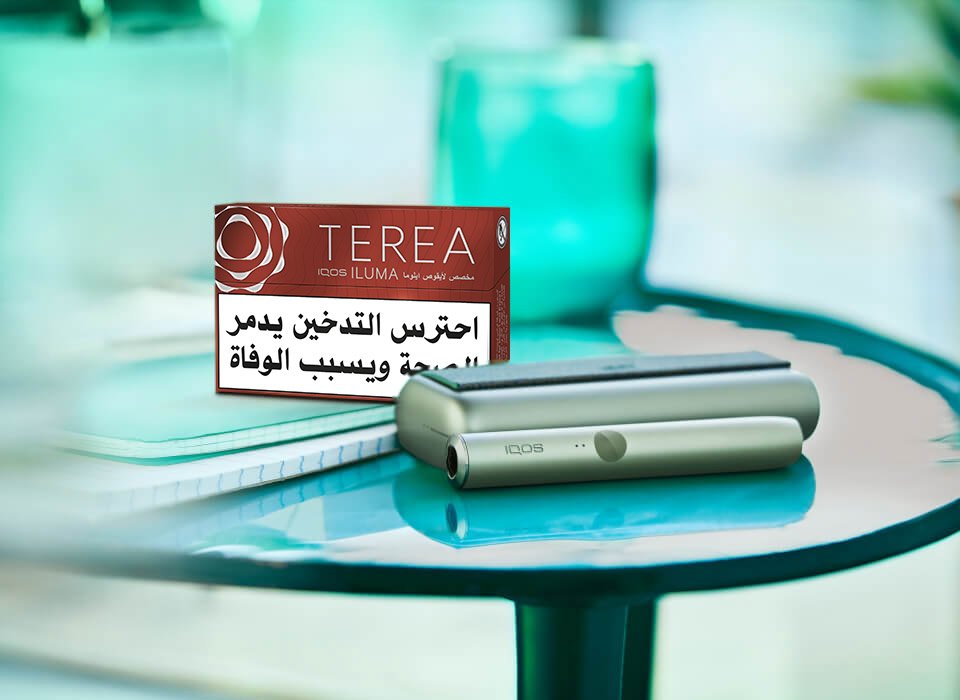 IQOS TEREA pack and an IQOS ILUMA Prime on a table