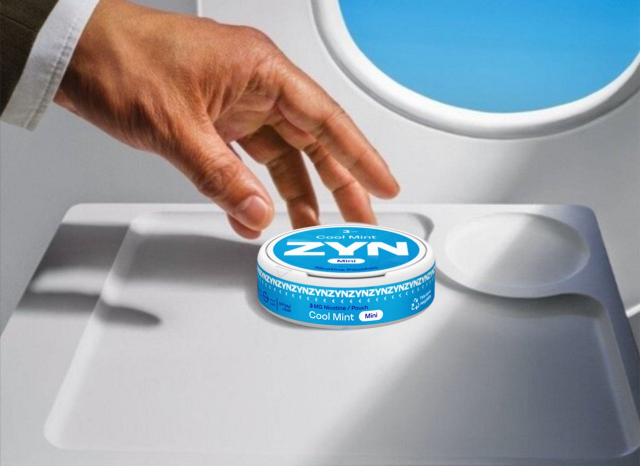 Image of a Cool Mint ZYN can on an airplane tray.