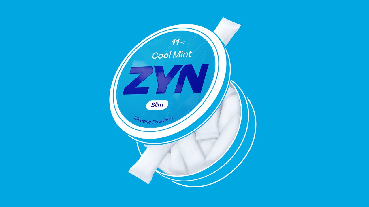 Open ZYN Cool Mint Slim 11 mg can filled with white nicotine pouches on a blue background.