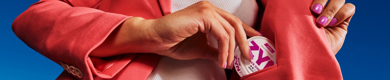 Two women hugging and a third women looking at them and smiling