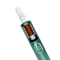 Close-up view of a green IQOS ILUMA i device with visible heating element, digital display, control buttons, and inserted TEREA stick.