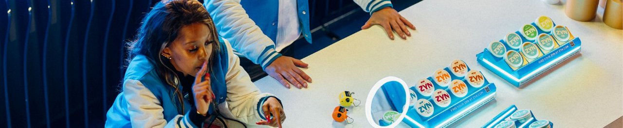 Two women hugging and a third women looking at them and smiling