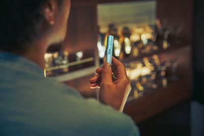 holding green ILUMA device