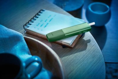 green ILUMA device on notepad