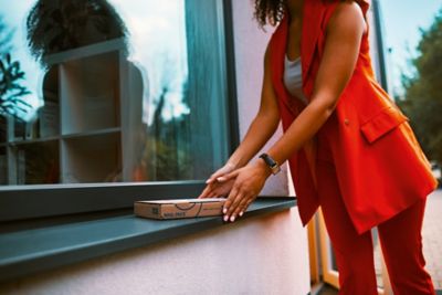 Woman looking at IQOS packaging