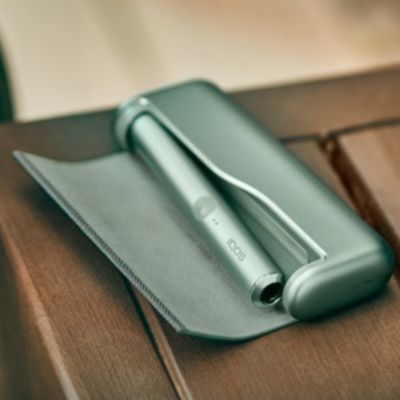 A Jade Green IQOS ILUMA PRIME Pocket Charger.