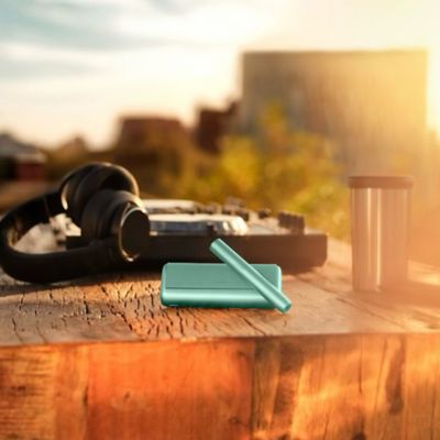 A Jade Green IQOS ILUMA PRIME Pocket Charger.