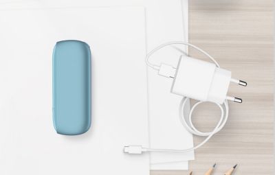 Turquoise IQOS ORIGINALS DUO pocket charger next to cable charger.