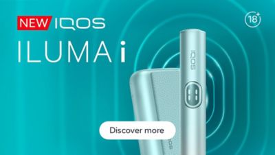 Close-up of an IQOS ILUMA i PRIME against a futuristic teal abstract background with radiating curved lines.