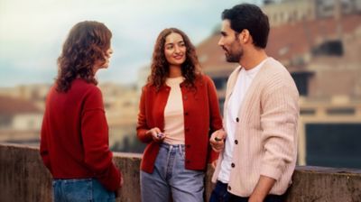 3 people talking outside