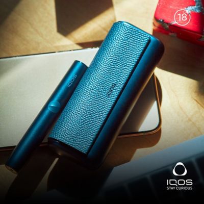 IQOS ILUMA Charger on top of a table