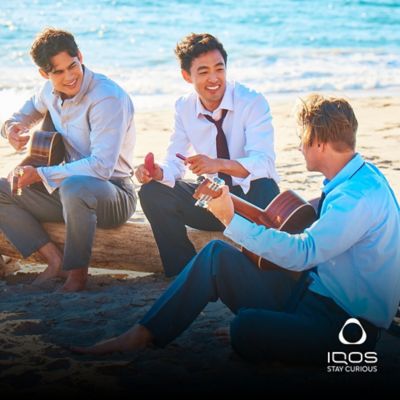 Three friends singing along by the beach