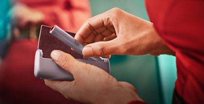 An  IQOS ILUMA Holder and Pocket Charger.