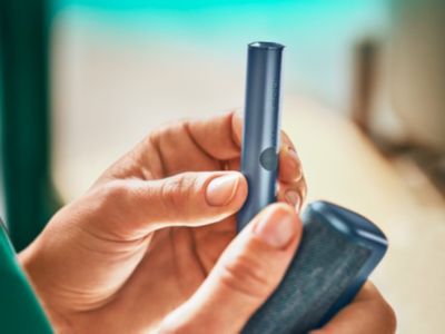 An Azure Blue IQOS ILUMA PRIME Holder and Pocket Charger.