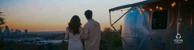 A couple camping together and looking over the horizon