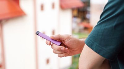 man holding disposable vape