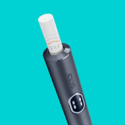 A Moss Green IQOS ILUMA with a TEREA stick inserted.