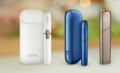 An IQOS ILUMA PRIME, IQOS ILUMA and IQOS ILUMA ONE, set against a blurred background