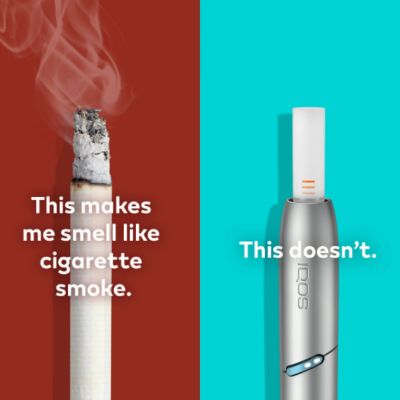 IQOS Originals DUO holder, next to a cigarette with smoke