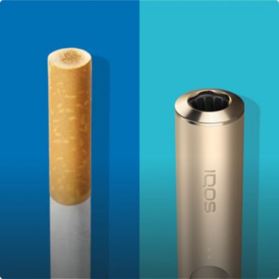 Cigarette filter with brown combustion stains compared to IQOS TEREA stick in an IQOS ILUMA holder with no equivalent stain.