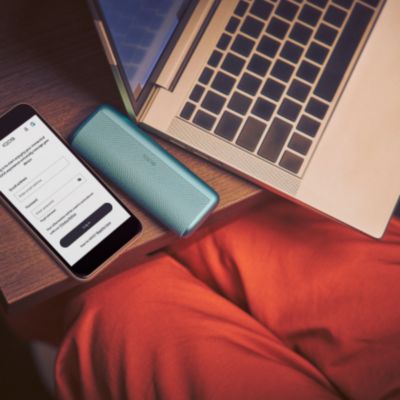  Modré zariadenie IQOS ILUMA i PRIME na stole s telefónom a notebookoma