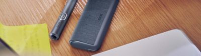 IQOS ILUMA i PRIME Midnight Black auf Schreibtisch liegend