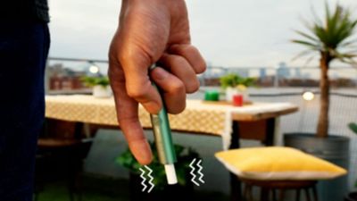 Girl showing a gold IQOS holder