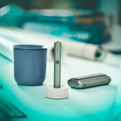 A person places a TEREA stick into an IQOS ILUMA PRIME Holder.