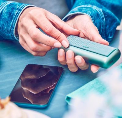 A Jade Green IQOS ILUMA PRIME Holder and Pocket Charger.